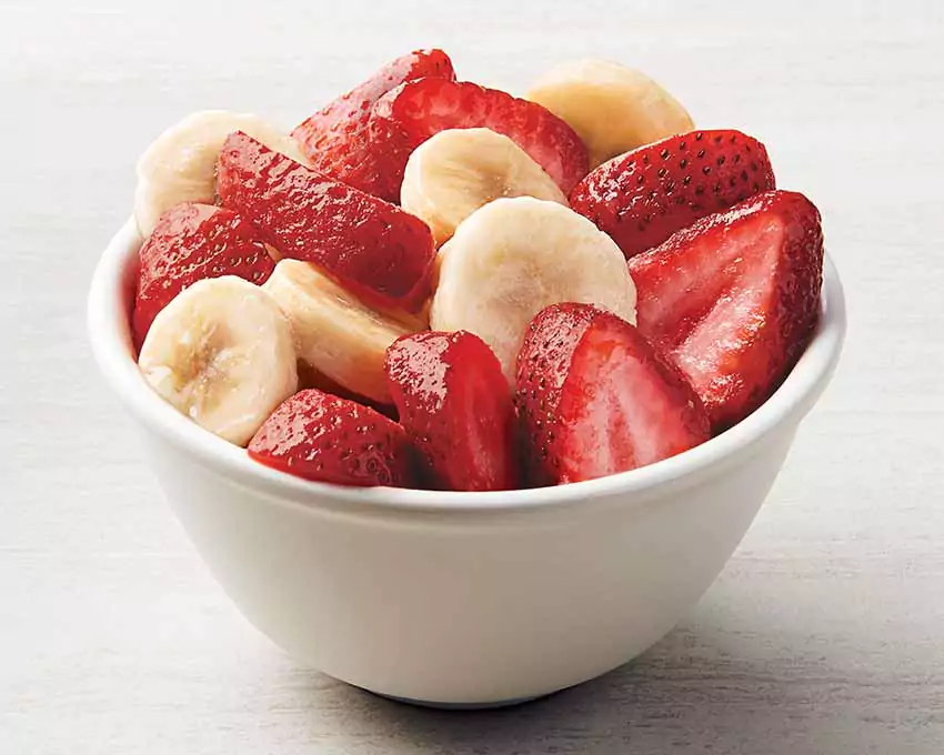 a bowl of sliced strawberries and bananas